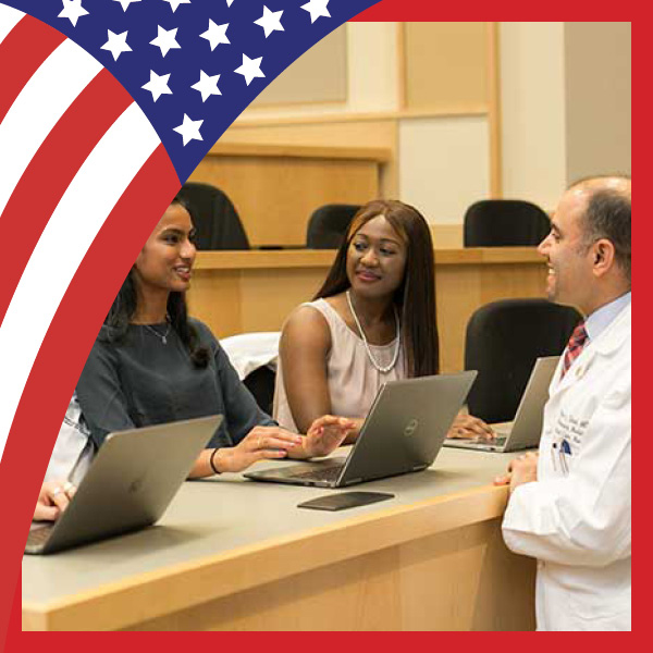 Medical students meeting in a small group with a faculty member