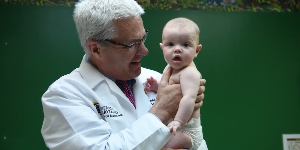 Dr. James Campbell holds a baby