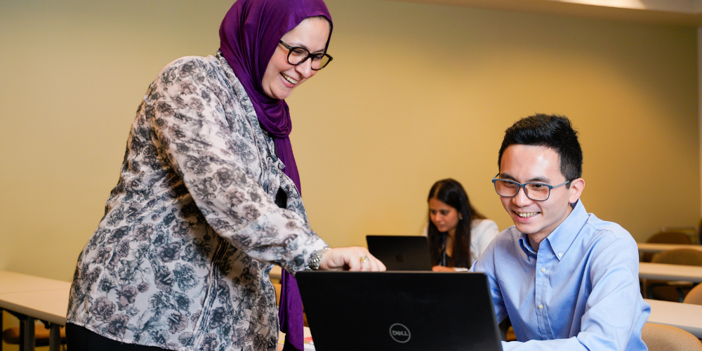 Dr. Danya Qato helps a student