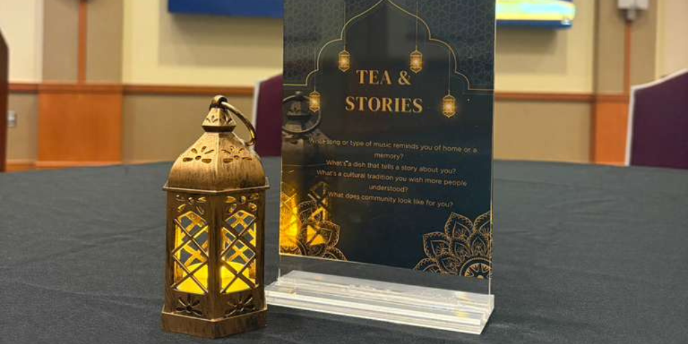 A lantern and event flyer sit on a table
