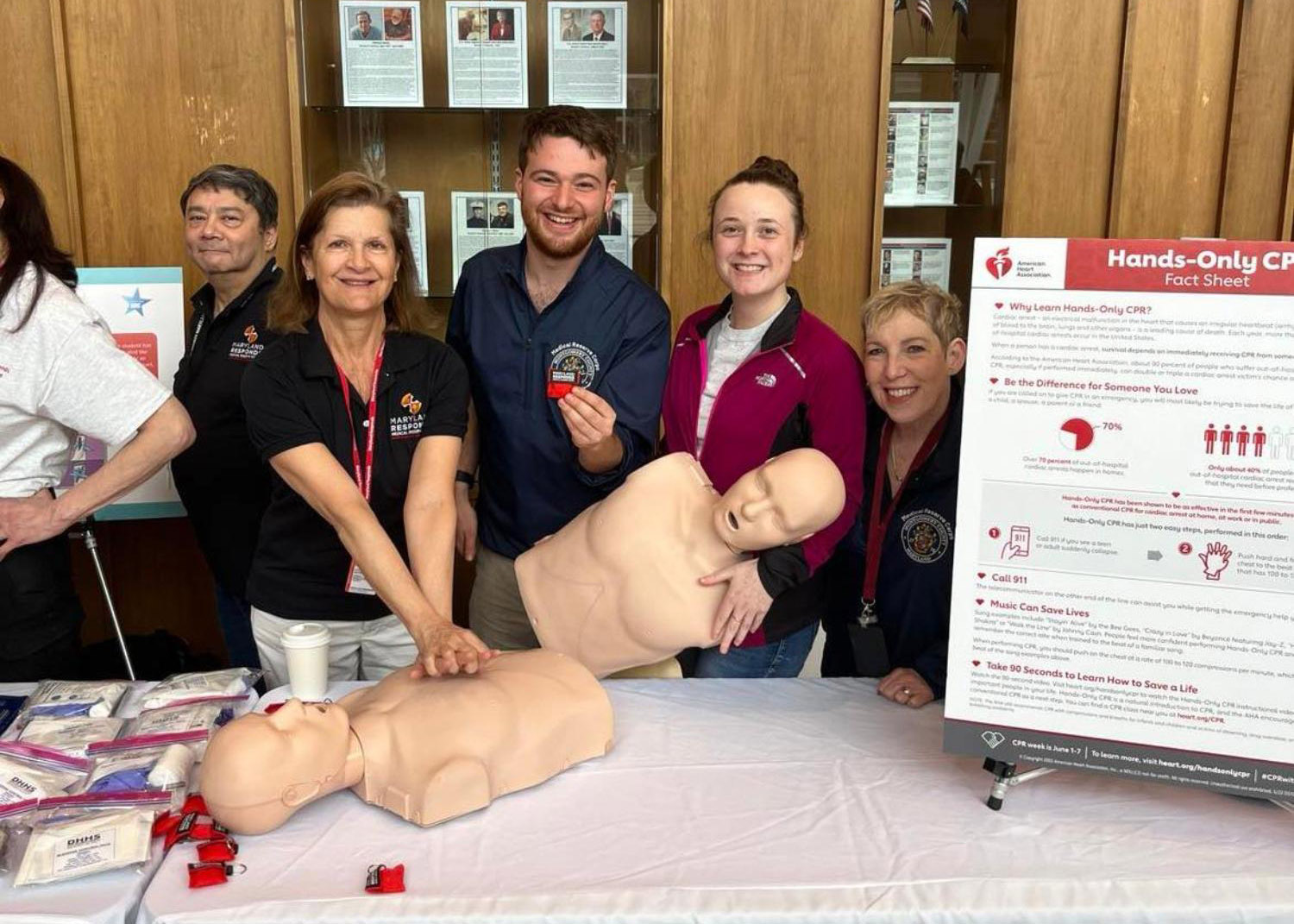 four adults learn and demonstrate cpr