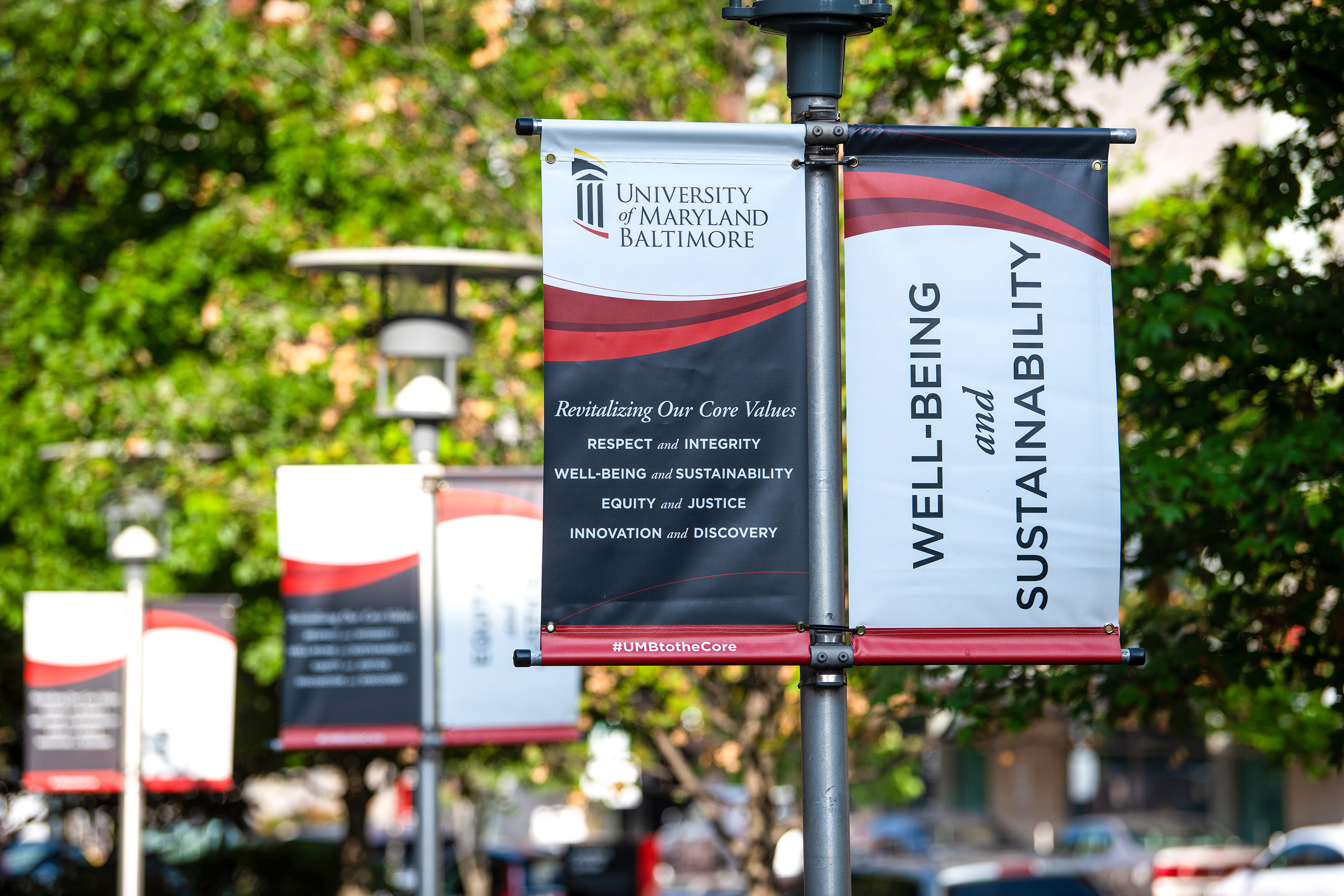 A banner outside with the 8 core values of Respect and Integrity, Well-being and Sustainability, Equity and Justice, Innovation and Discovery