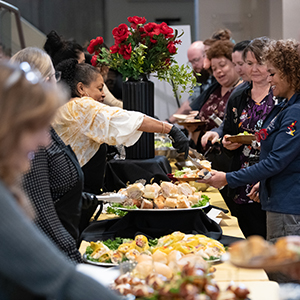 Group of staff being served lunch by UMB Employees.