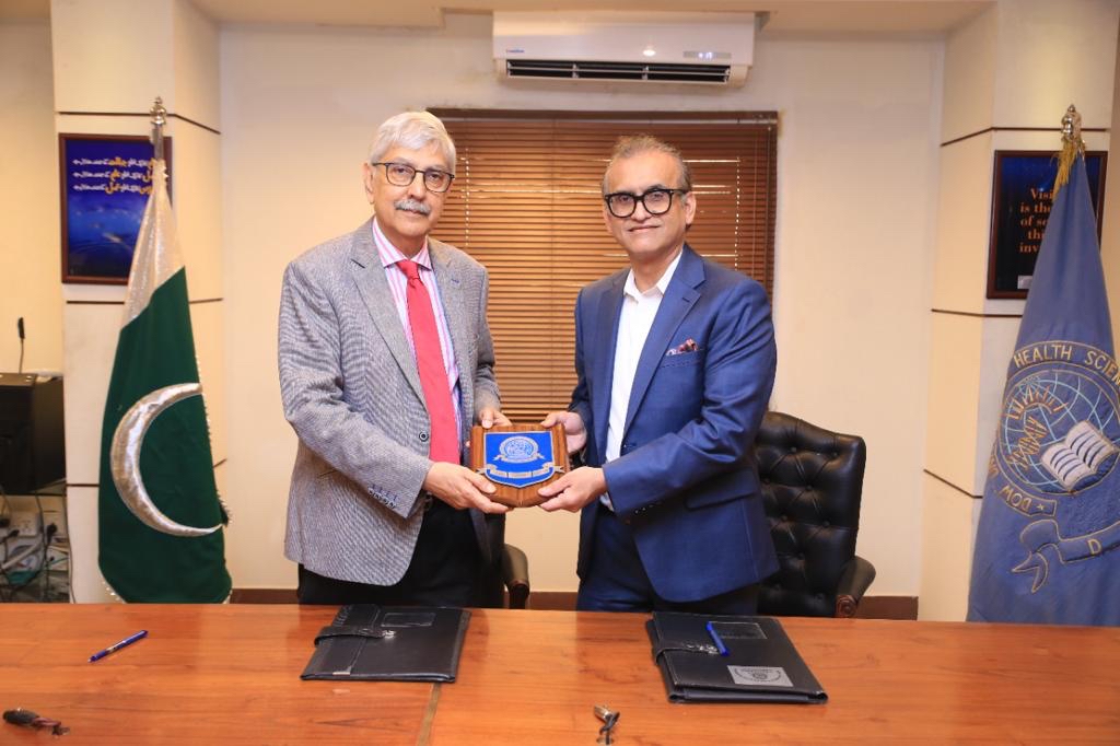 Dr. Muhammad Mohiuddin poses with a representative from Dow University of Health Sciences