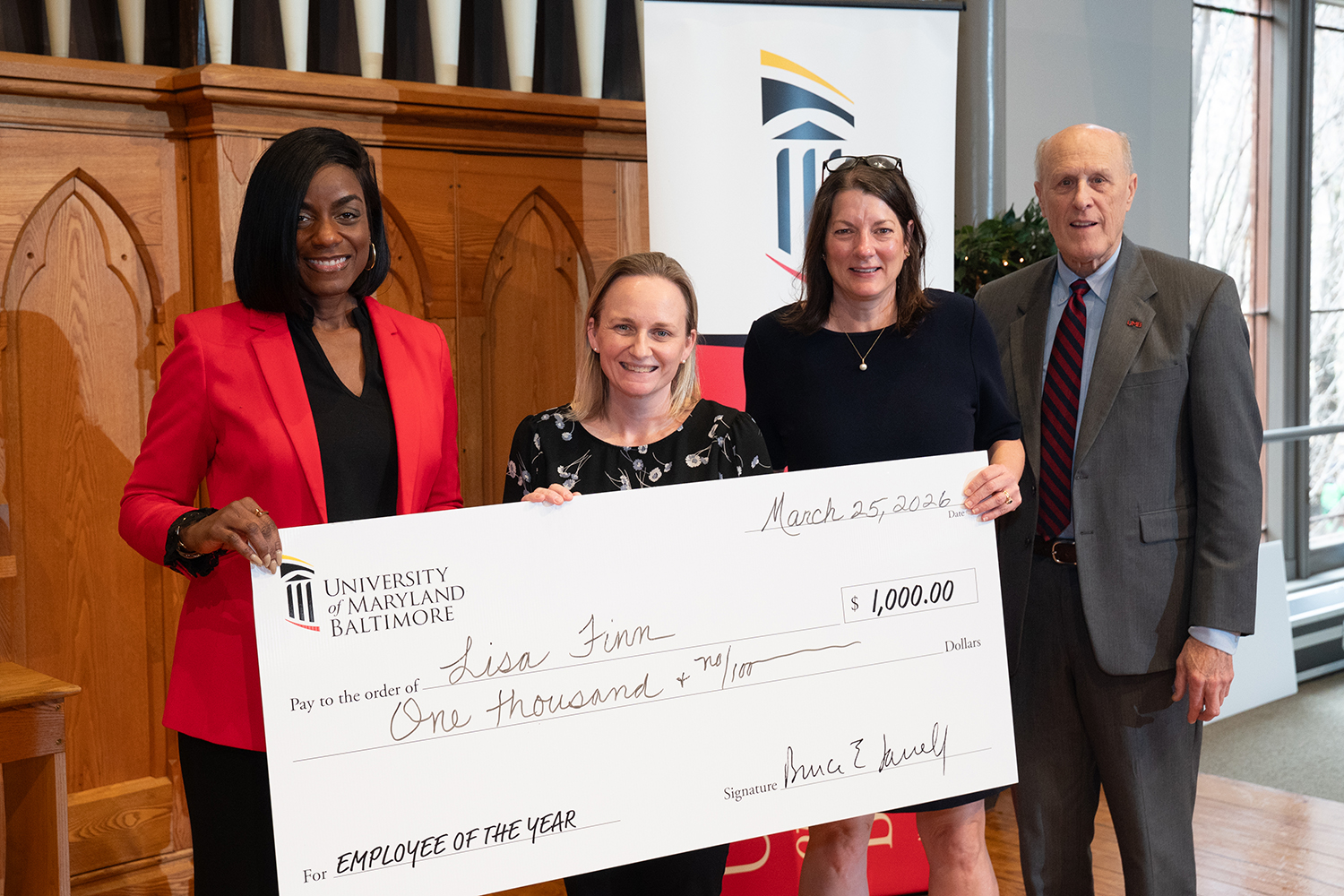Lisa Finn (second from left) stands with (from left) Malika Monger, Agnes Ann Feemster, and Bruce Jarrell.
