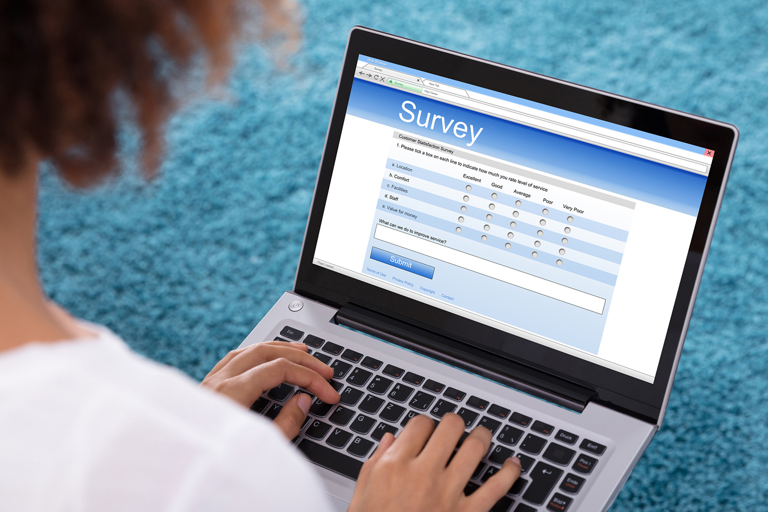 person fills out a survey on a laptop