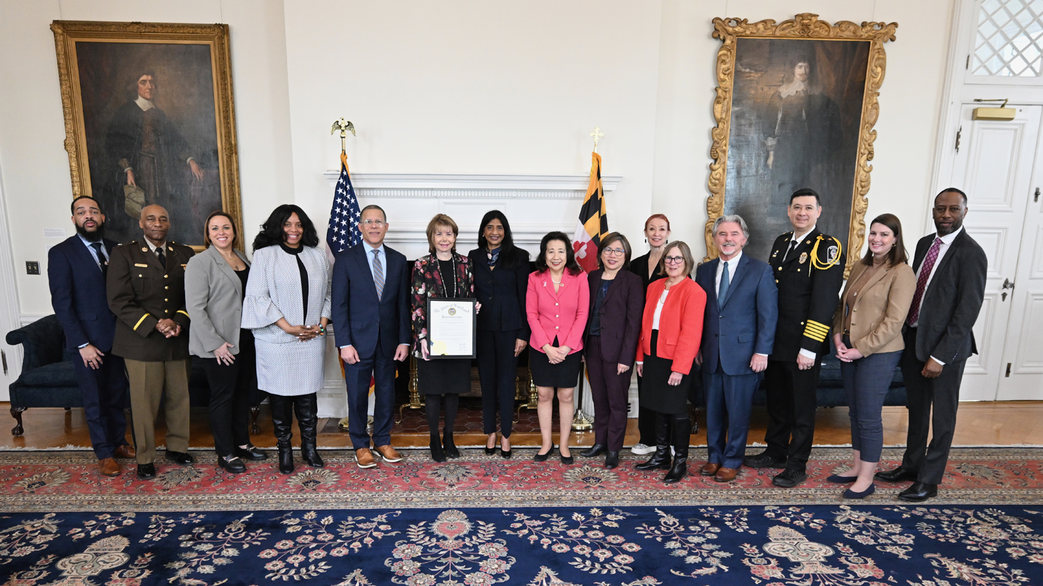 UM SAFE Center CEO Susan Esserman holds a proclamation, flanked on her left by Lt. Gov. Aruna Miller, Secretary of State Susan Lee, and Secretary of Labor Portia Wu, and on her right by Attorney General Anthony Brown and trafficking survivor Stacy Jewell.