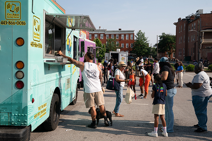 Guests line up at a variety of food trucks during OCCE’s Juneteenth Jubilee celebration