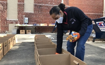 Gia Grier McGinnis, DrPH, MS, the executive director of the UMB CURE Scholars Program sorts the food donations for the annual Thanksgiving food drive.