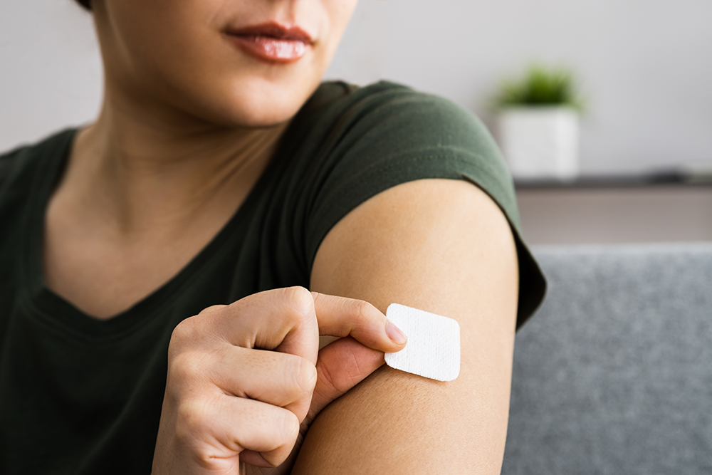 A woman putting a patch