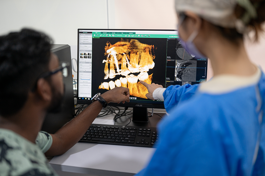 People looking at a dental x-ray