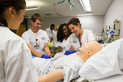Students gathered around a patient