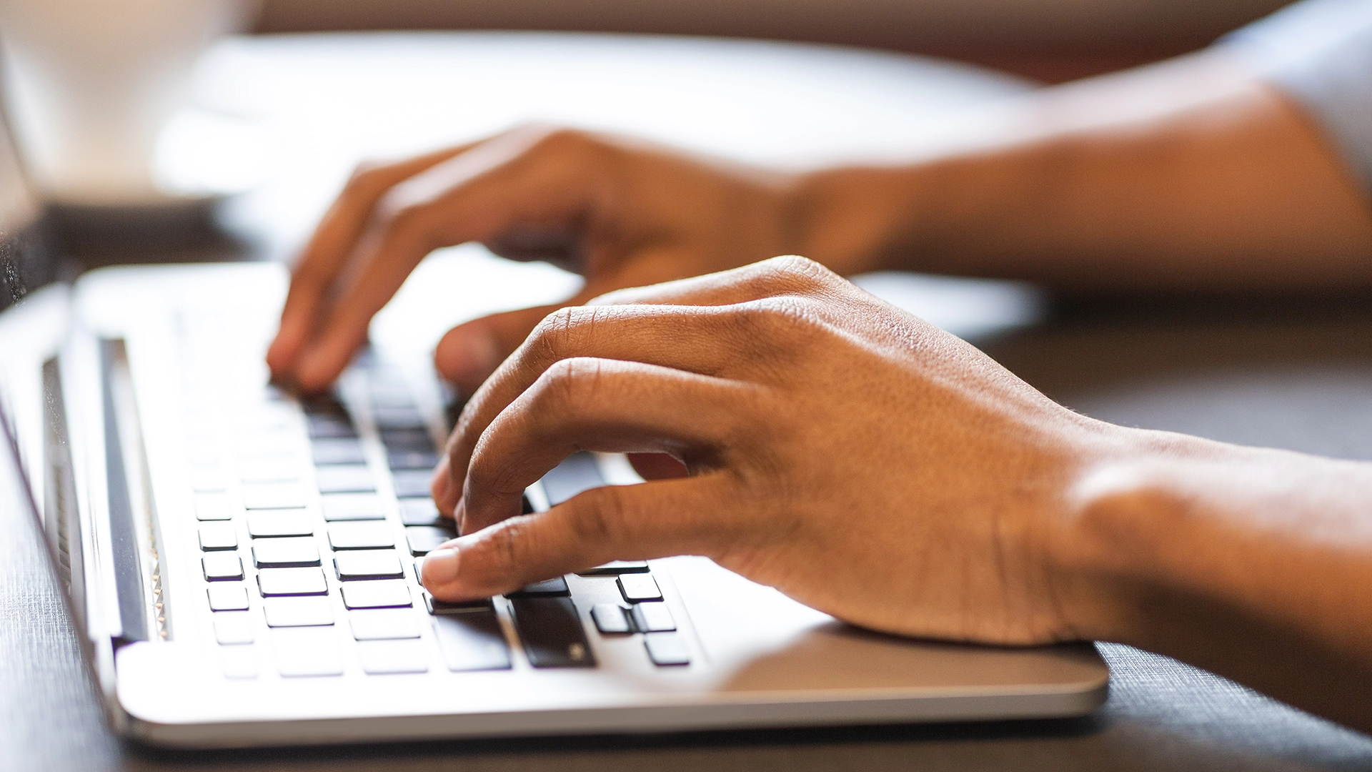 Typing on a laptop